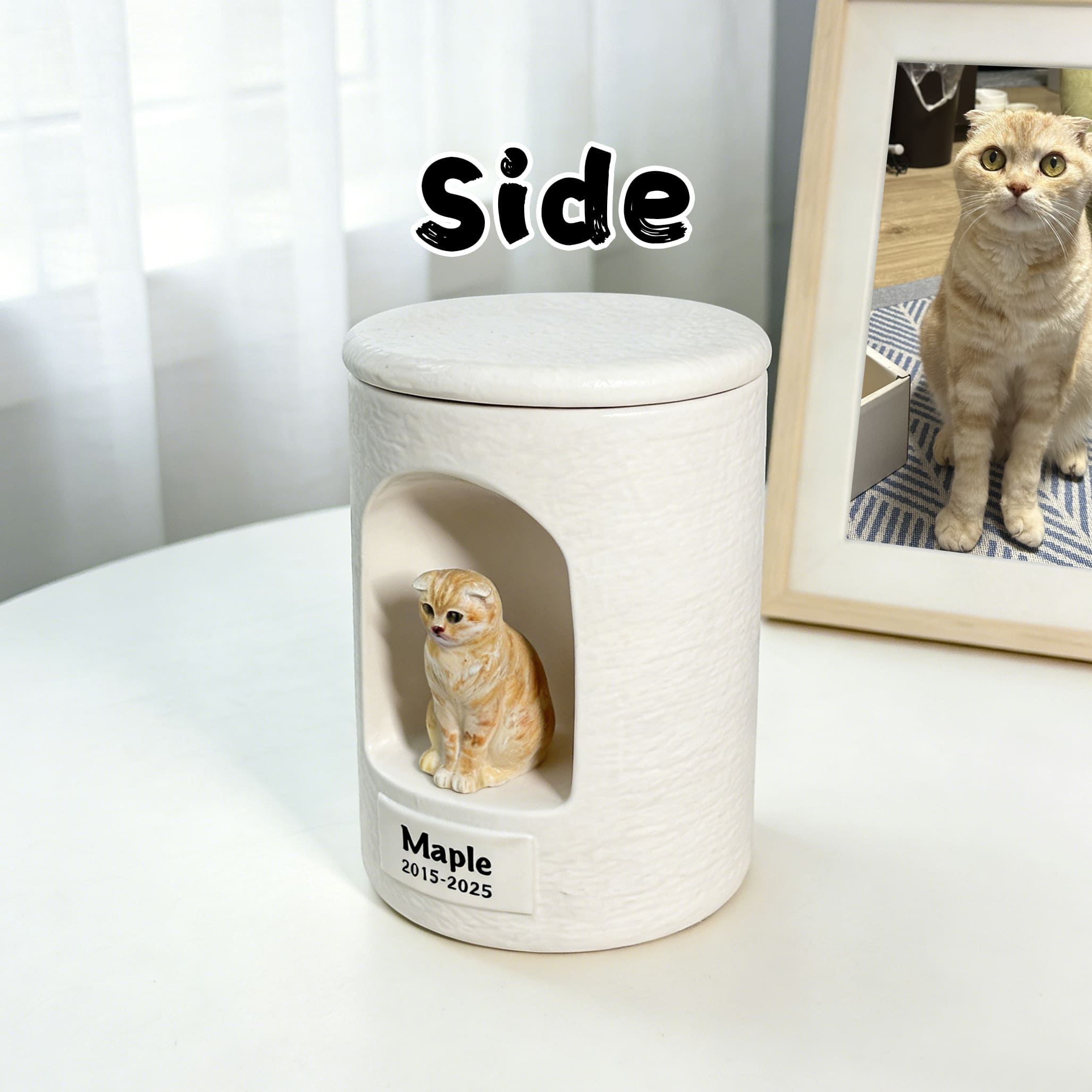 White ceramic side-view cat urn with sculpted tabby figurine and name/date engraving