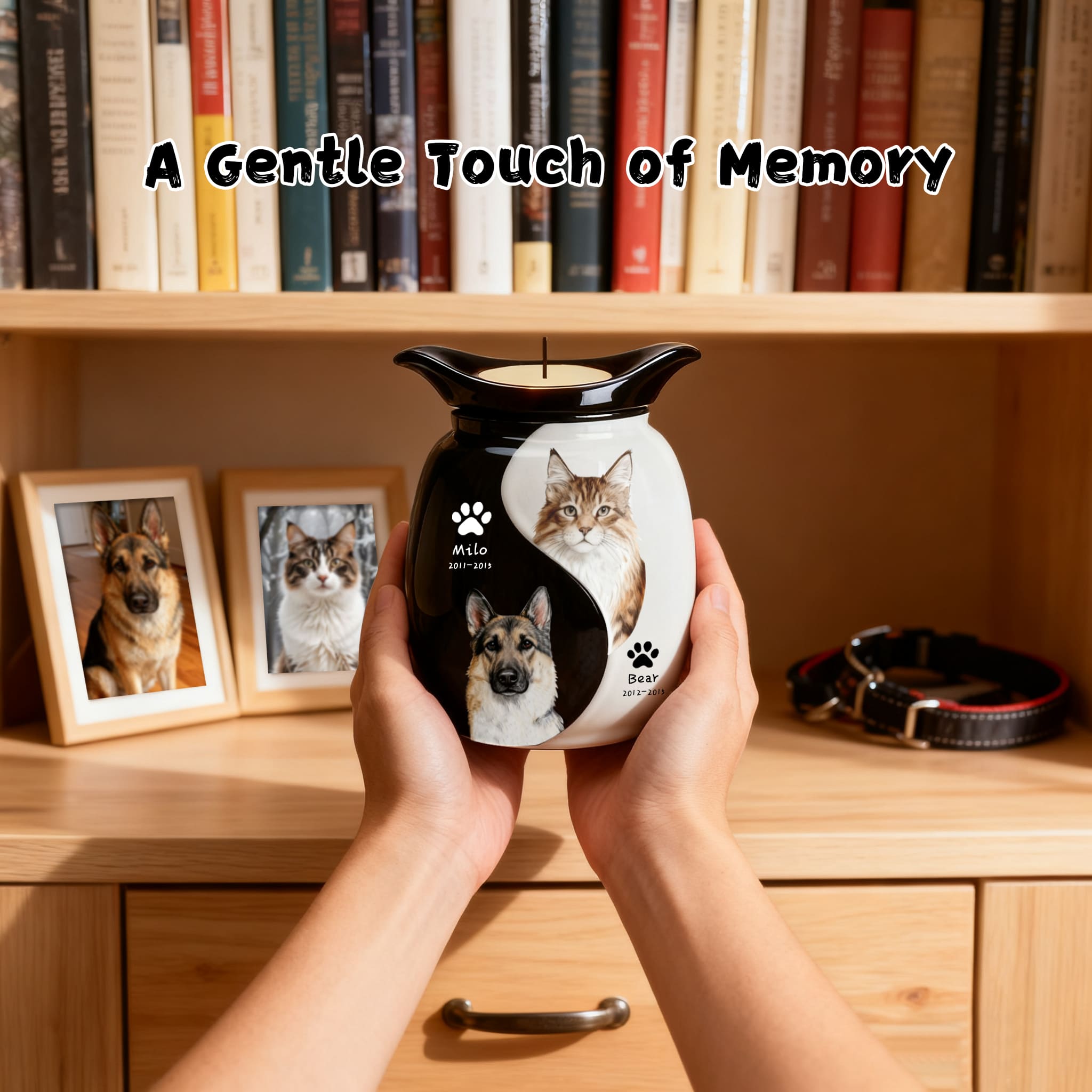 Hands holding black-and-white double pet urn with lit tealight and two pet photo panels