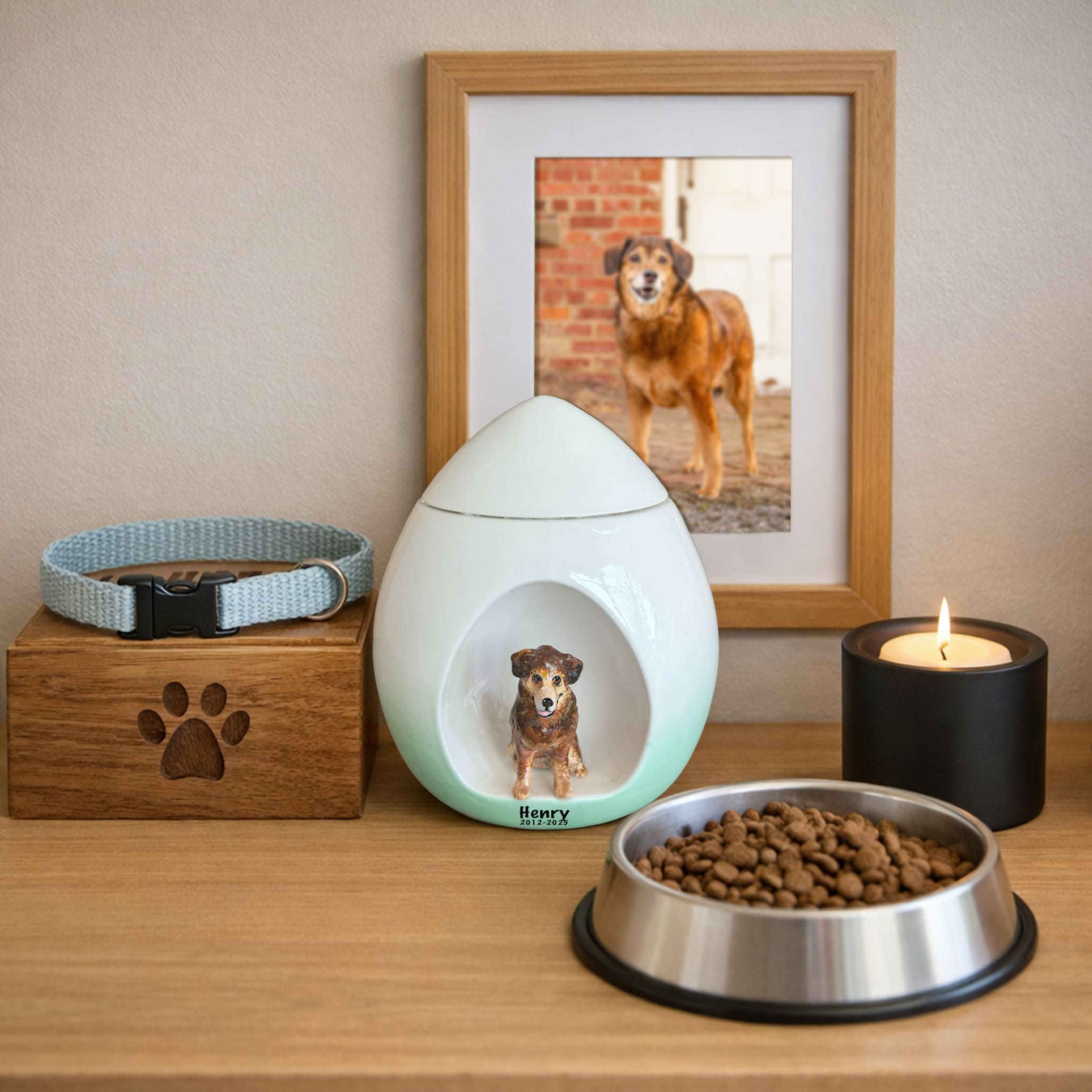 White pet urn with mint-green base and dog figurine inset, displayed on a tabletop