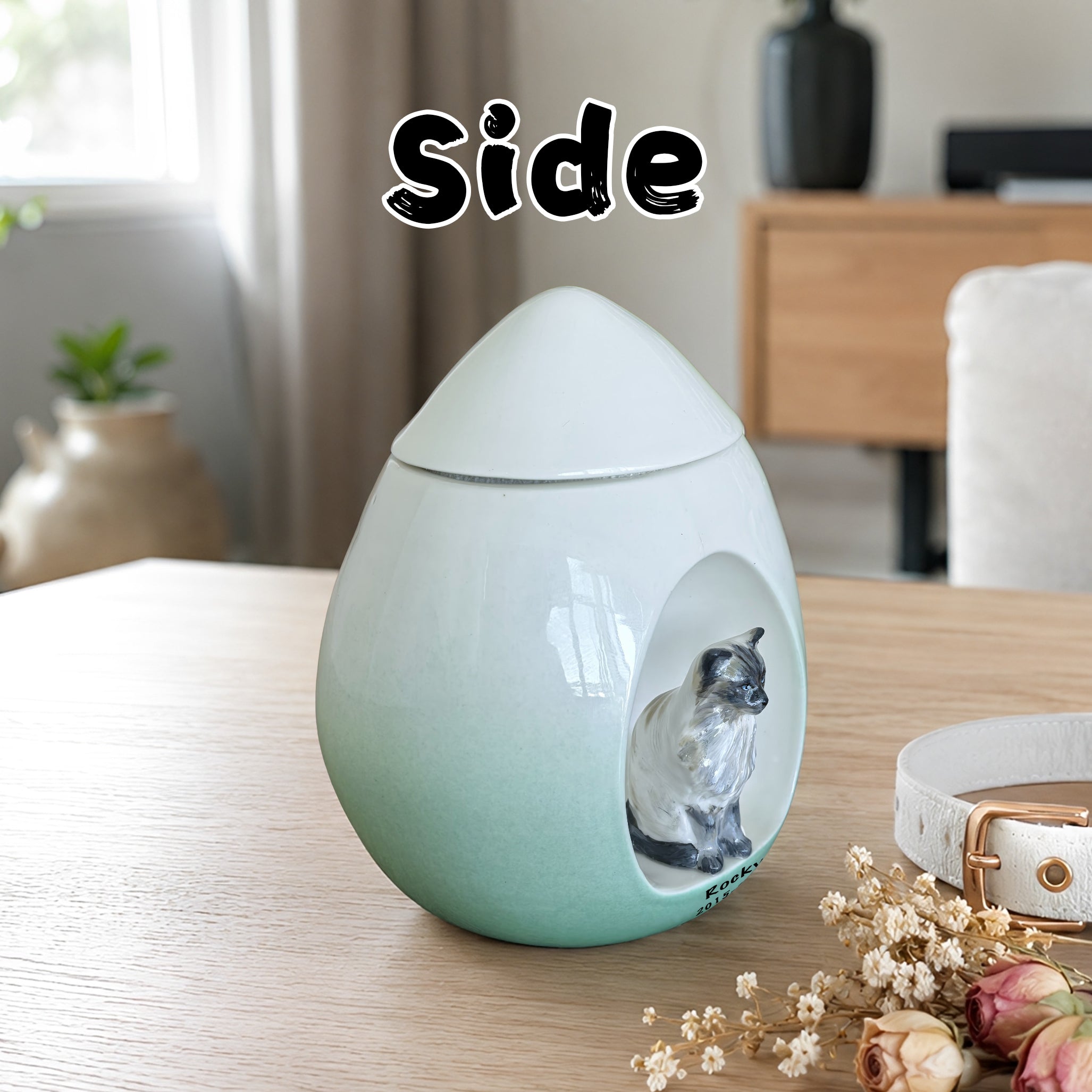 Side view of a personalized ceramic cat urn with hand sculpted cat figurine