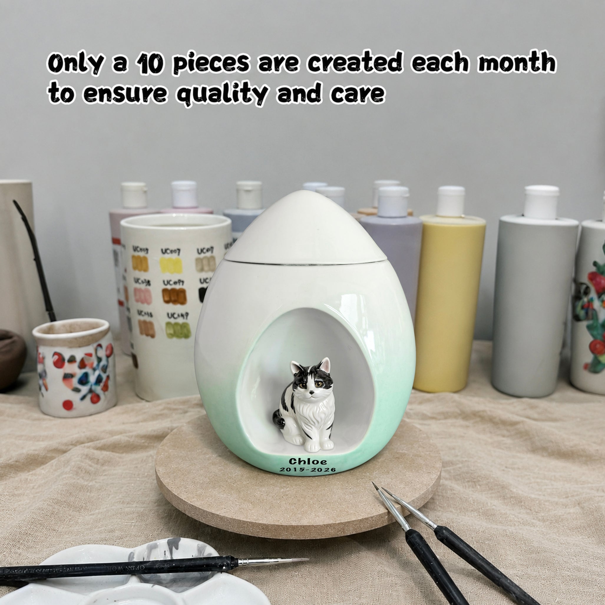 Handmade ceramic cat urn in the studio showing limited monthly production and hand painted details