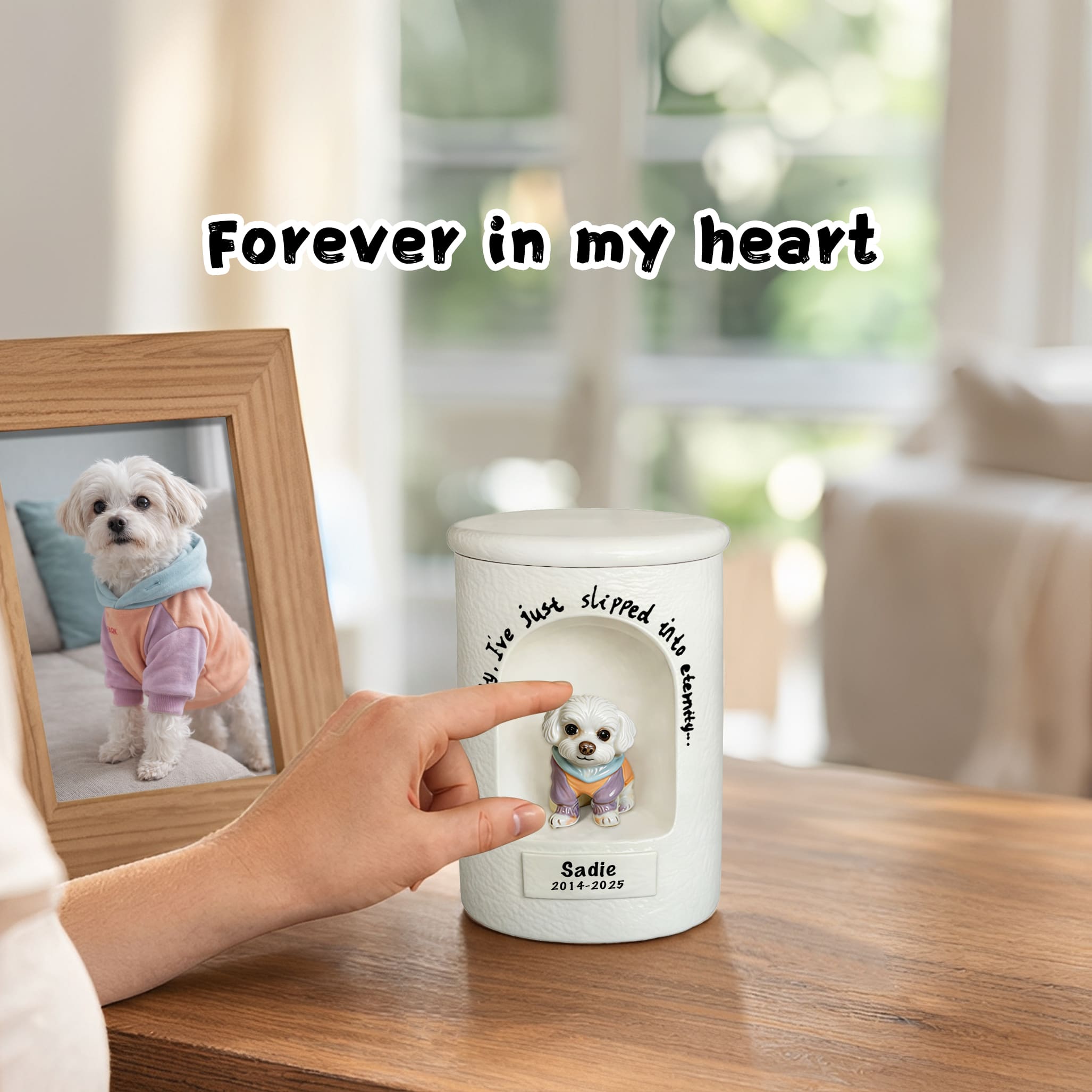 White ceramic dog urn with seated dog figurine relief and engraved name, held in hand