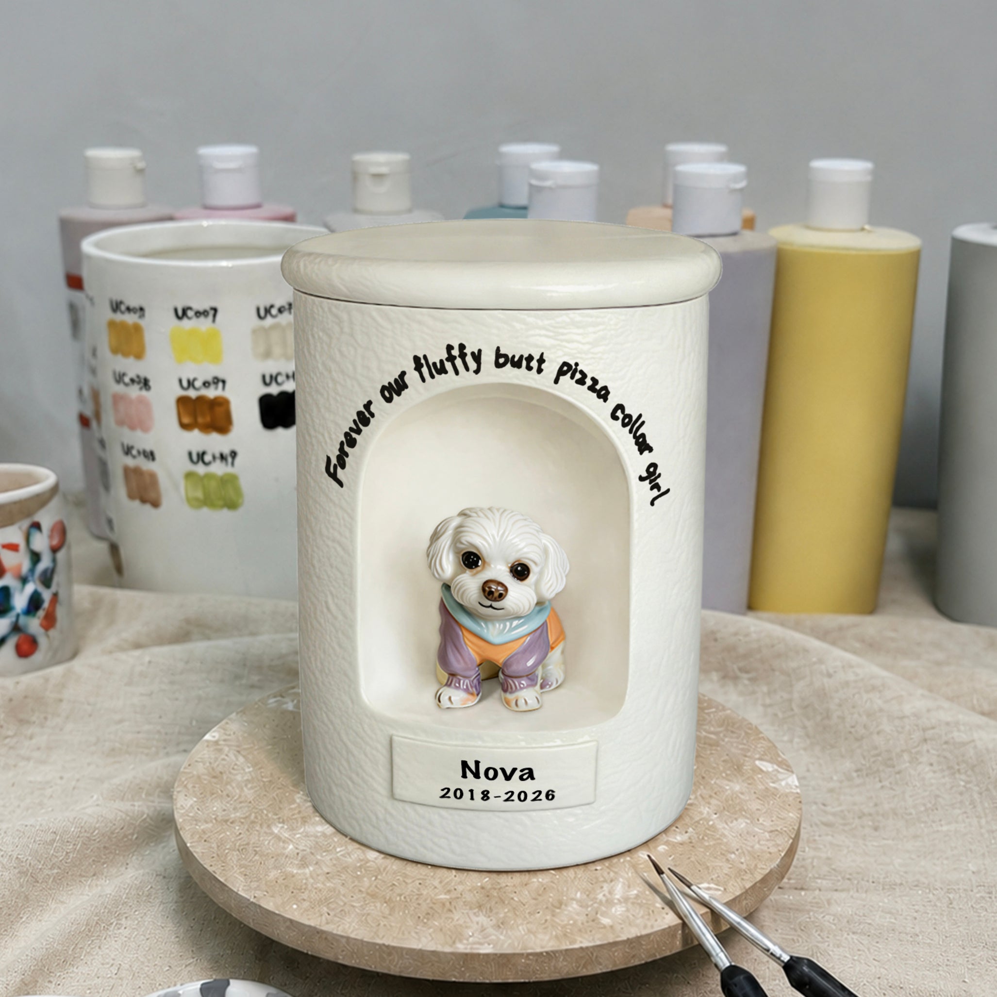 White pet urn with dog graphic, custom phrase, Nova 2018–2026 on front base