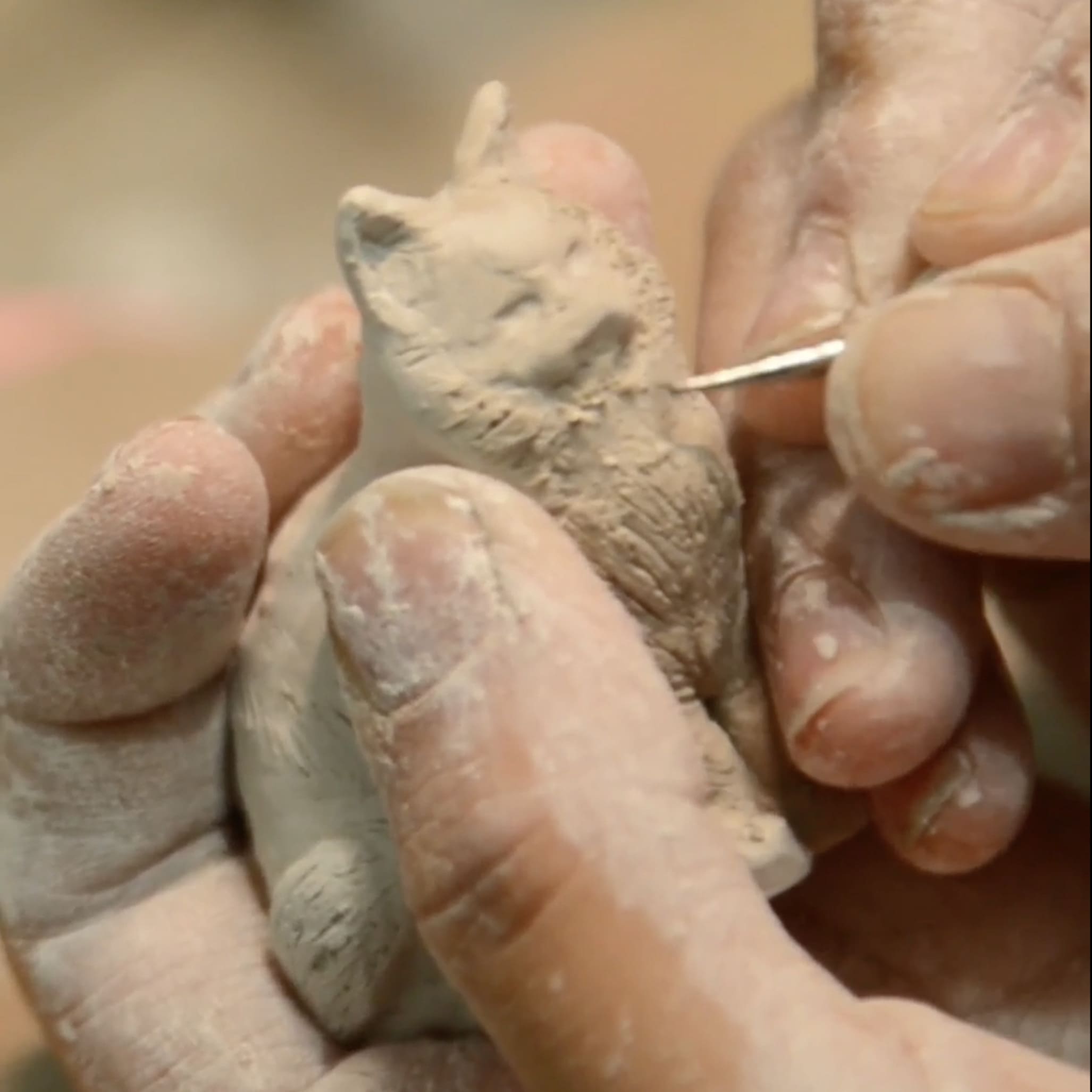 Personalized ceramic cat urn making process with handcrafted figurine and hand-painted memorial details.