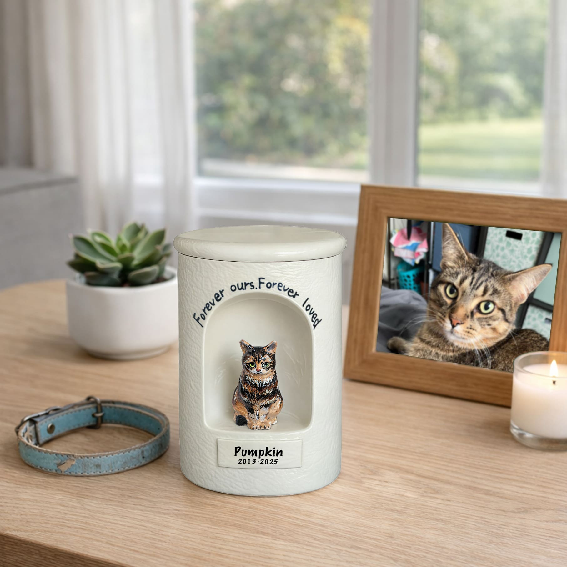 White memorial cat urn with sculpted figurine and engraved memorial phrase on front
