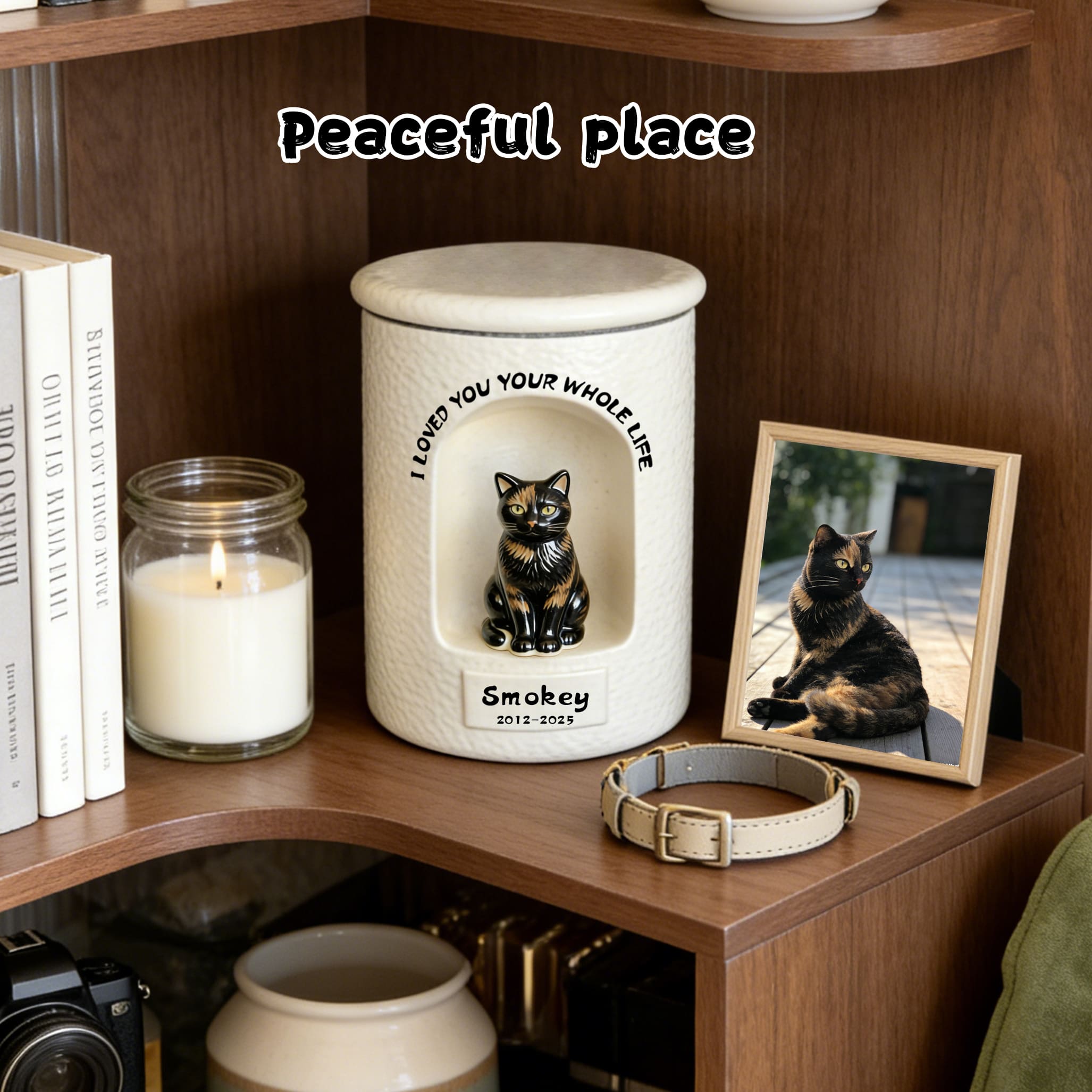 White ceramic pet urn with sculpted cat figurine and engraved name and years on front
