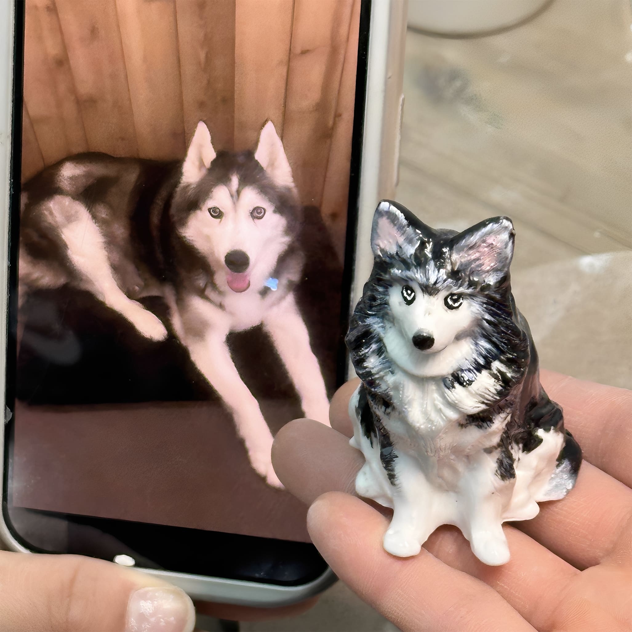 Ceramic dog figurine sculpt of husky-style dog in cupped hands