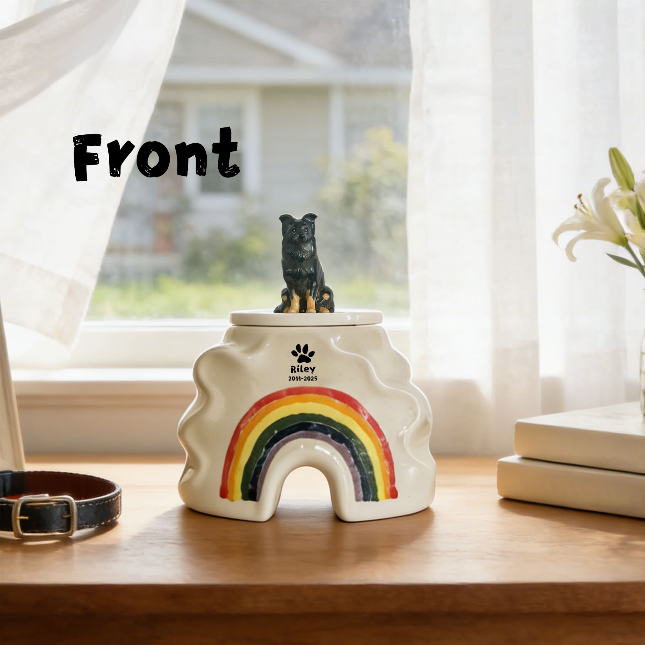 Cream ceramic pet urn with black dog figurine on lid and rainbow front opening