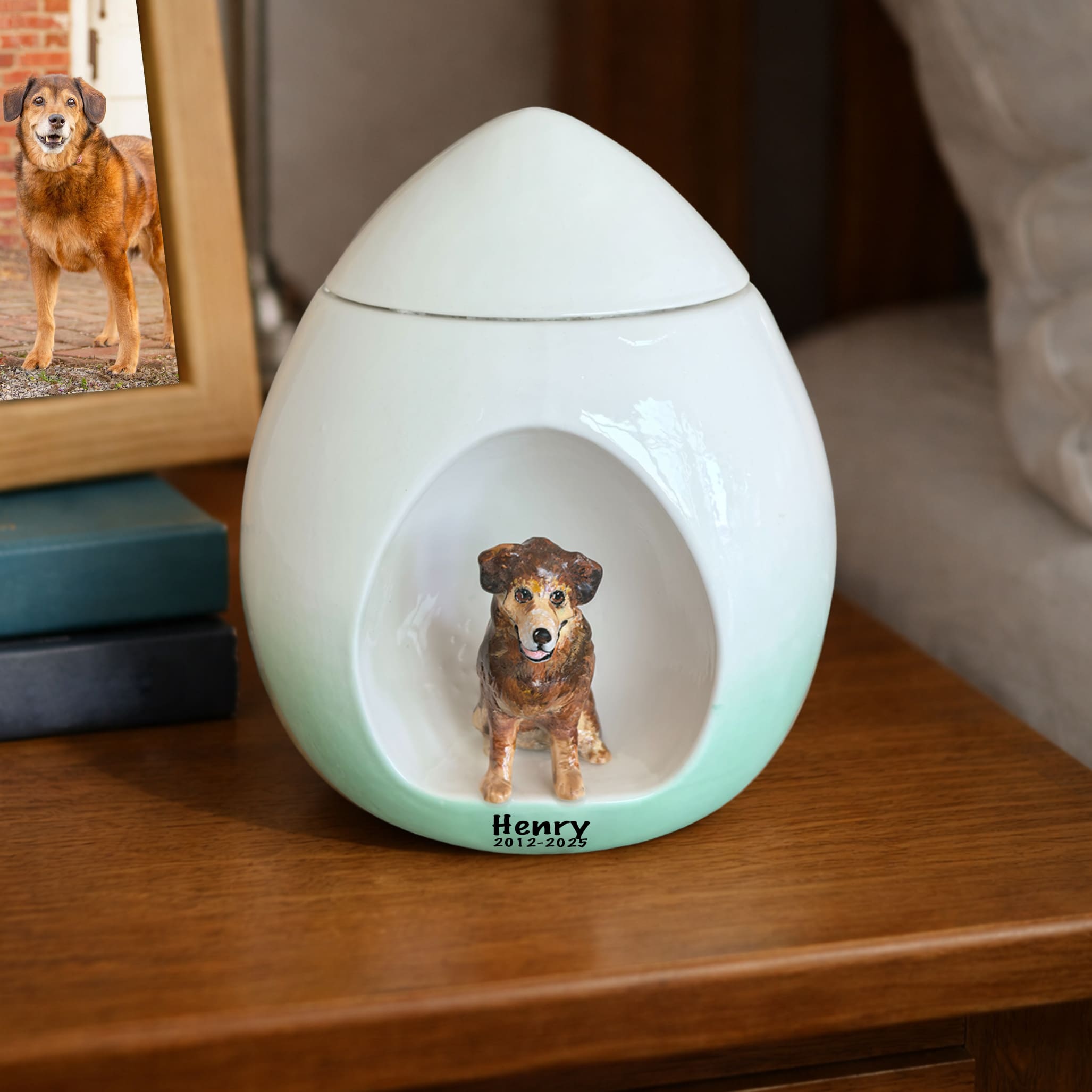 White pet urn with mint-green base and a seated dog figurine inset with engraved name
