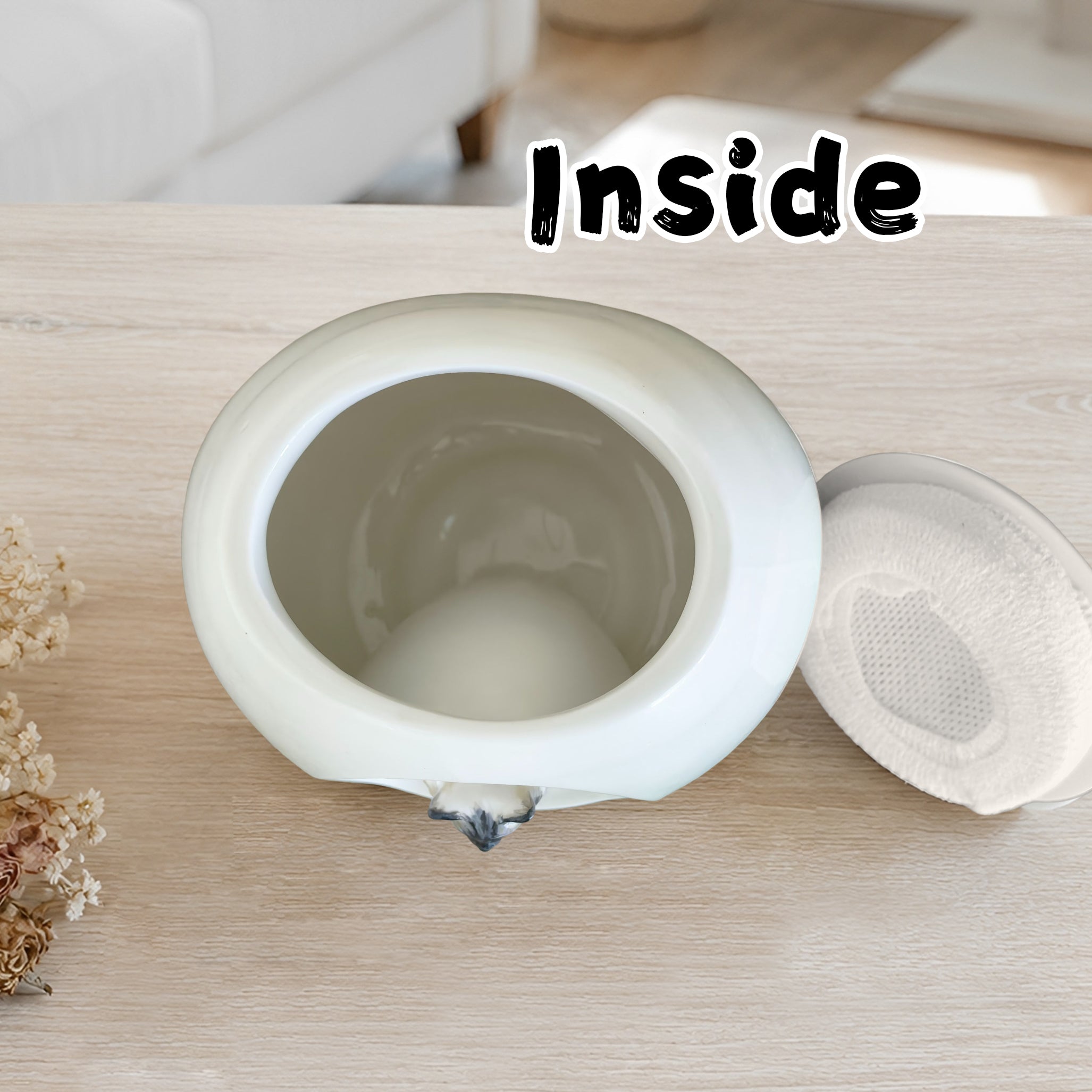 Inside view of a ceramic cat urn showing the inner space designed to hold pet ashes