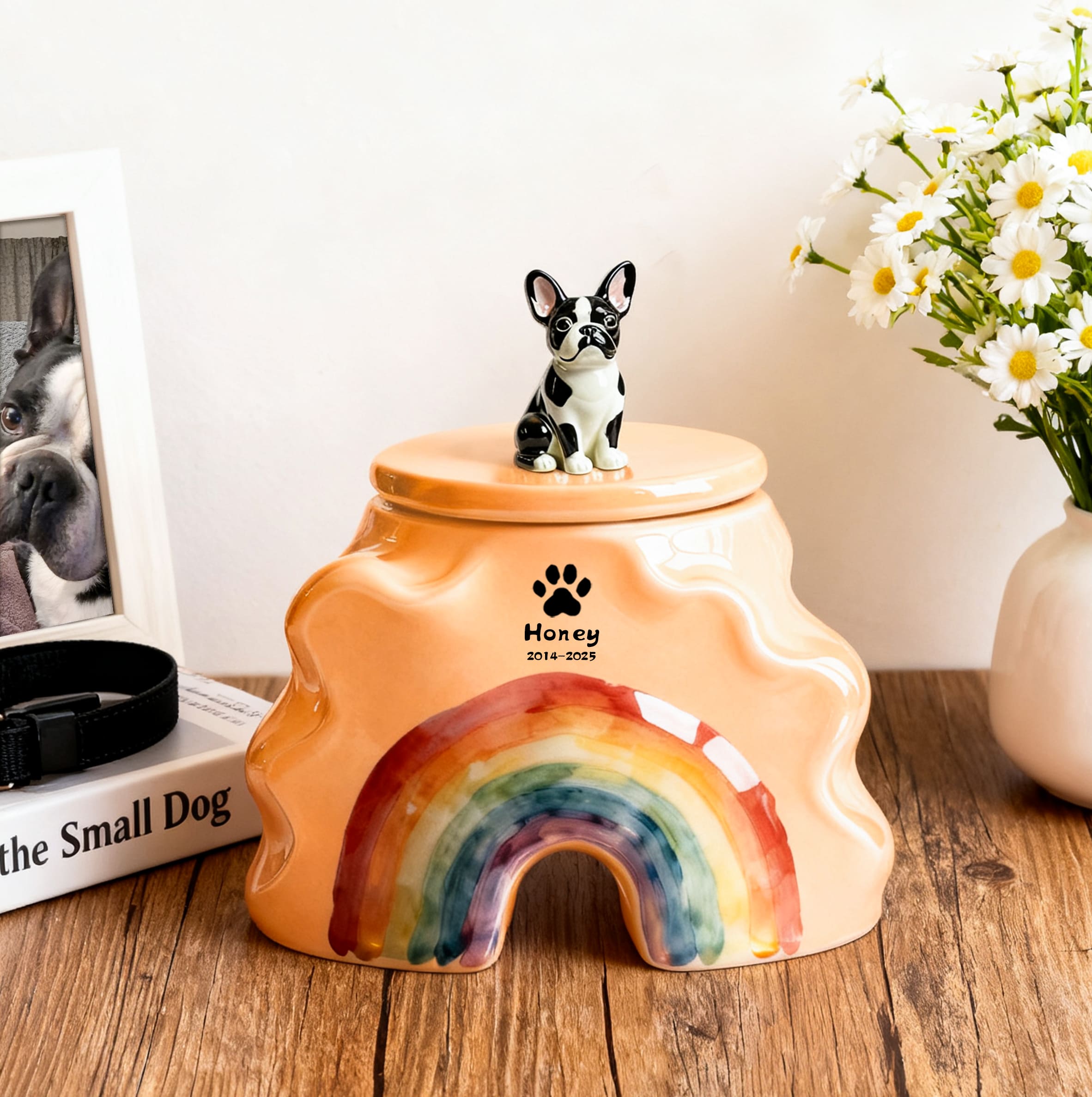 Orange ceramic pet urn with black dog figurine lid and rainbow front opening